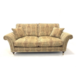 Parker Knoll Burghley large two seater sofa upholstered in Baslow Medalli Gold fabric, raised on turned front supports and brass castors, W203cm