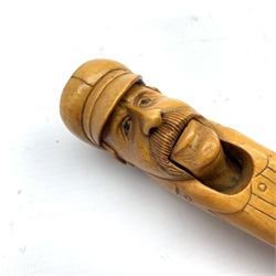  Black Forest type novelty lever-action nutcracker, carved as a bearded gentleman wearing a cap and a buttoned coat, L19cm  