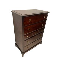 Stag Minstrel - mahogany chest of drawers, fitted with four long and three short drawers, raised on bracket supports