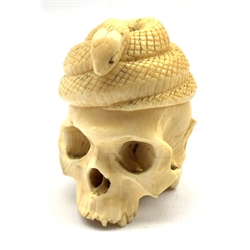 Late 19th century Japanese carved ivory okimono in the form of a skull beneath a coiled snake with a toad at the rear H5cm 