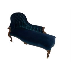 Late 19th century rosewood framed chaise longue, the buttoned back and sprung serpentine seat upholstered in royal blue velvet fabric, the arm terminals carved and scrolled and the apron with central foliate motif, raised on cabriole supports terminating in ceramic castors
