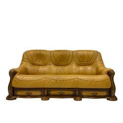 20th century oak framed sofa, upholstered in mustard leather fitted with drawers, together with two armchairs of the same design 
