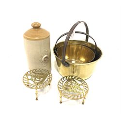 Two brass jam pans, two trivets and stoneware water bottle 