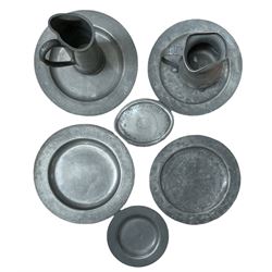 19th century pewter plates, two bearing a monogram, two pewter tankards and a teapot stand