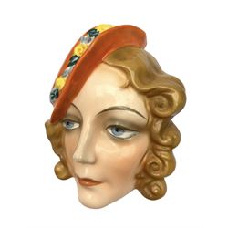 Art Deco Czech wall mask modelled as a lady wearing an orange hat, L17.5cm 