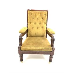 Victorian mahogany open armchair, upholstered in green buttoned velvet, with scroll carving to arm terminals, raised on turned and reeded front supports with later brass cup castors W73cm