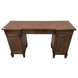 William IV mahogany reverse-breakfront twin pedestal sideboard, shaped rectangular top with moulded edge, fitted with four frieze drawers with stepped chamfer facias, the pedestals enclosed by figured panelled doors revealing single shelf and cellarette drawer, raised on moulded ogee feet