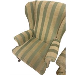 Parker Knoll - pair of wingback armchairs, upholstered in striped fabric, raised on cabriole supports 