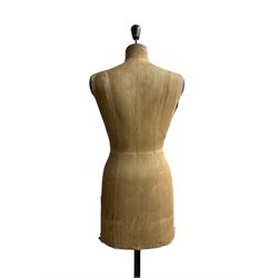 Early 20th century female torso dressmakers dummy or mannequin by Stockman, stamped 'Stockman, Paris-London, Brevete S.G.D.G./5169' of cloth construction on telescopic cast iron base with four legs and castors, H158cm x W40cm 
