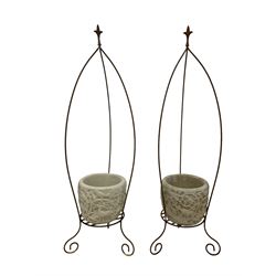 Pair composite stone planters with wrought metal stands, the planter decorated with a tree of life relief 