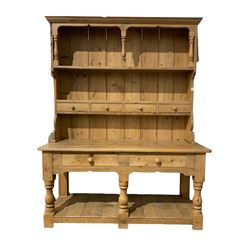 Victorian style pine dresser, the projecting cornice over two tiered plate rack with four spice drawers over base with two long drawers and pot board base, raised on turned and block supports W165cm, H210cm, D63cm