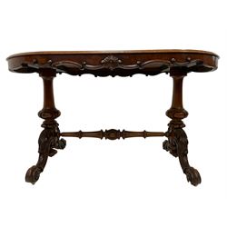 Late 19th century walnut stretcher table, shaped frieze with carved cartouche and scroll decoration, raised on twin pillars with lobe detail, cabriole supports with acanthus leaf carved united by turned stretcher
