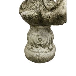 Constituted stone garden ornament in the form of a fleur-de-lis, base decorated with acanthus leaves
