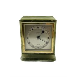 Elliott - 20th century timepiece 8-day mantle clock, in s recangular green onyx case with a stepped top and base, silvered dial with a narrow chapter ring, Roman numerals, minute track and pierced steel hands, within a glazed square brass bezel, movement wound and set from the rear.