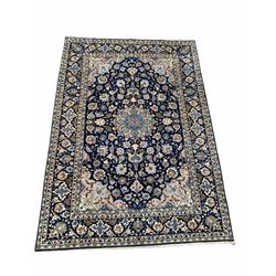 Persian Isfahan ground carpet, blue field centred by floral medallion and bordered 417cm x 285cm