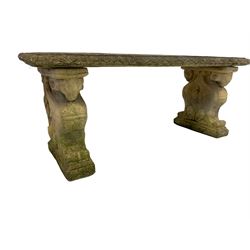 19th century design composite stone three-piece garden bench, the rectangular seat with acanthus leaf border, the end supports in a scrolled foliate form enclosing poppies with rams head capitals