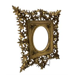 Rococo style gilt framed wall hanging mirror, the frame with scrolled and conforming acanthus leaves enclosing oval mirror 56cm x 45cm