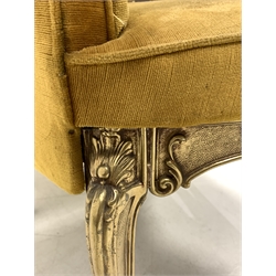 Pair of Italian cast brass open armchairs, seat and back upholstered in yellow velvet, the frame with scrolled floral decoration, raised on cabriole supports, W55