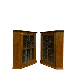 Pair oak corner cabinets, enclosed by lead glazed door