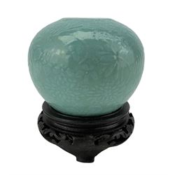 Chinese Qing dynasty turquoise glazed water pot, decorated in low relief with flowers and stylized motifs, Qianlong mark beneath, with hardwood stand, H8cm