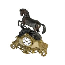 French - early 19th century 8-day mantle clock c1820, with a gilt spelter and alabaster base surmounted by a simulated bronze horse,  white enamel dial with Roman numerals and pierced gilt hands, count wheel striking movement with a silk suspension, striking the hours and half hours on a bell. 