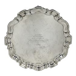 Silver circular salver with moulded edge and scroll feet with presentation inscription and a list of names engraved to the reverse D30cm Sheffield 1964 Maker Viners Ltd 24.7oz