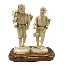 Two 19th century Japanese sectional carved ivory Okimonos, the first depicting a woodcutter with a roll of logs on his back, the second of a farmer, both signed on a single hardwood base H16cm max (2)