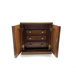 Victorian mahogany collectors cabinet, the hinged lid above two cupboard doors enclosing three graduated drawers with turned ivory handles, H35cm, W34cm x D25cm