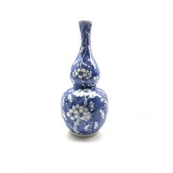 20th century Chinese gourd shape vase decorated with prunus in blue and white with four character mark to base H26cm