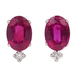  Pair of platinum oval ruby stud earrings, each set with a diamond, stamped Pt 900, ruby total weight 2.00 carat   