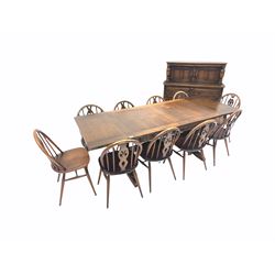 Ercol dining room suite, to include a duo drawer leaf dining table (214cm x 84cm) set of ten hoop back dining chairs (W43cm) and a sideboard / court cupboard (123cm)