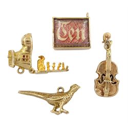 Four 9ct gold pendant/charms including ten money note, violin, old woman who lived in a shoe and pheasant