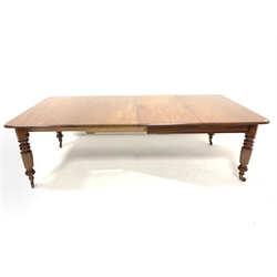 Victorian mahogany extending dining table with two additional leaves, raised on turned supports and brass cup castors, 247cm x 122cm, H73cm