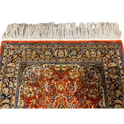 Fine Persian amber ground rug, the field with a central floral pole medallion surrounded by all-over scrolled foliate patterns and palmette motifs, the guarded indigo border with repeating interlocking foliage