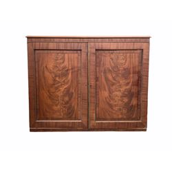 Late Georgian mahogany dwarf press, two fielded panelled figured doors with beaded moulding and ebony string inlay enclosing four slides, raised on castors,  W124cm, H100cm, D59cm