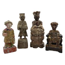 Chinese Qing dynasty carved and painted figure of a Deity seated on a throne, script to the reverse, another standing figure wearing a gold tunic and two others H18cm (4)