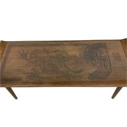 Mid to late 20th century Singapore hardwood table, carved with dragon and figural scenes, inset glass top, on tapering supports
