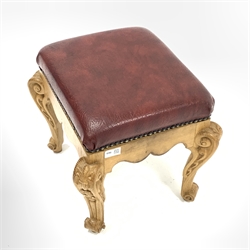 20th century carved oak footstool, with studded faux leather upholstered top  over shaped apron and leaf carved and scrolled supports, W39cm