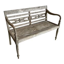 Regency Revival - teak two-seat garden bench, flower head carved horizontal rails over slatted seat, shaped arms on turned supports 