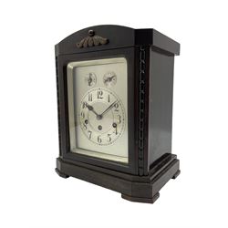 Early 20th century German Westminster chiming mantle clock in a ebonised finished wooden case, eight-day spring driven  three train movement manufactured by “Juhngans” c1910, sounding the quarters and hours on 4 gong rods, with a silvered dial plate, chapter ring, Arabic numerals and minute track, subsidiary dials for pendulum regulation and chime/silent facility, glazed door with a silvered slip. With pendulum and key.