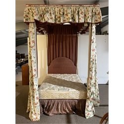 Cream painted 4' small double four poster bed, turned and fluted upright supports on stepped and moulded plinths, shaped headboard upholstered in red fabric, draped in floral pattern fabric 
Provenance: From the Estate of the late Dowager Lady St Oswald