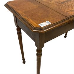 Edwardian oak metamorphic 'Britisher Writing Table', rectangular hinged top revealing correspondence compartments and hinged writing surface with pen rest and underside storage, flanked by twin hinged compartments with dividers, on turned supports