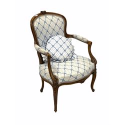20th century French stained beach framed fauteuil chair, floral carving to crest rail over seat and back upholstered in blue and white fabric, swept, fluted and scroll carved arm terminals raised on slender supports W62cm