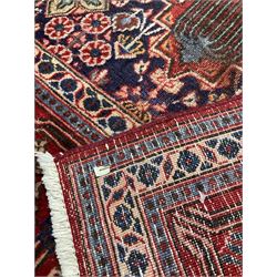 Handknotted Persian rug from Sanandaj region with five red medallions, navy field and red border (394cm x 275cm