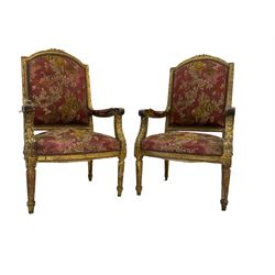 Pair Louis XVI design gilt framed armchairs, the cresting rail moulded with flower heads and roses, the frame moulded with ribbon fold border and beading, scrolled arm terminals decorated with acanthus leaves, raised on fluted tapering supports, upholstered in floral fuschia fabric with sprung seat