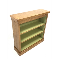 Figured oak open bookcase, cross banded and inlaid top over two adjustable shelves, plinth base, W96cm, H99cm, D30cm