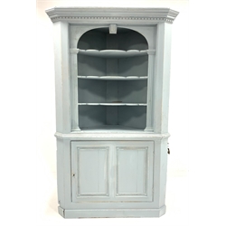 19th century oak floor standing corner cupboard, painted in egg shell blue, with dentil cornice over three shaped shelves enclosed by fluted pilasters, single panelled cupboard to base enclosing shelf with original green paint, skirted base, W120cm, H196cm, D80cm