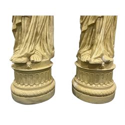 Pair Greek style caryatid columns, square top with gadroon underbelly, the semi-nude female figure draped in tied robe, circular stepped plinth base 