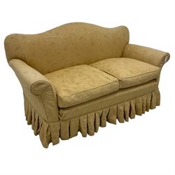 Late Victorian mahogany framed two seat humpback sofa, sprung back and seat upholstered in yellow foliate patterned damask fabric, on turned feet with castors
Provenance: From the Estate of the late Dowager Lady St Oswald