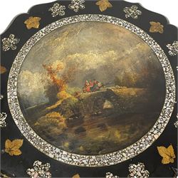 Victorian black lacquered papier-mâché occasional table, the shaped tilt-top decorated with painted landscape scene within a mother-of-pearl inlaid border, decorated with further mother-of-pearl and gilt foliage, on a turned stem, the platform base decorated with gilt work, on splayed and shaped metal feet
